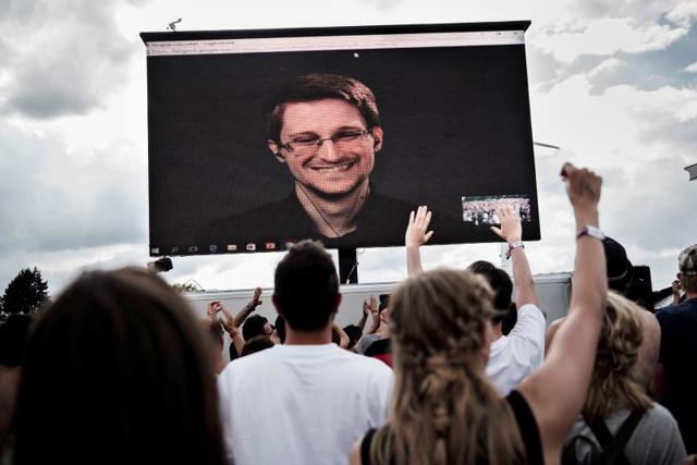 American whistleblower Edward Snowden is seen on a screen as he delivers a speech during the Roskilde Festival in Roskilde, Denmark. American whistleblower Edward Snowden is seen on a screen as he delivers a speech during the Roskilde Festival in Roskilde, Denmark.