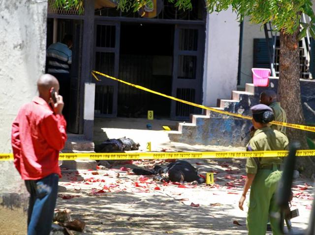 Kenya police officers look at the bodies of suspected attackers outside the central police station after an attack, in the coastal city of Mombasa, Kenya. (Reuters Photo) Kenya police officers look at the bodies of suspected attackers outside the central police station after an attack, in the coastal city of Mombasa, Kenya. (Reuters Photo)