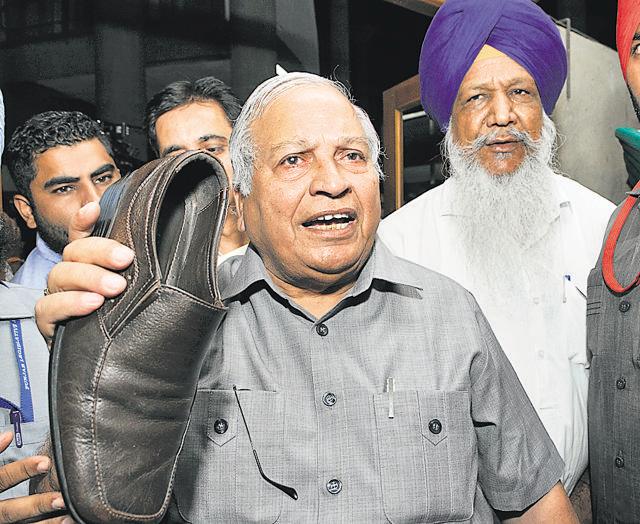 Minister Madan Mohan Mittal showing the shoe thrown by Congress MLA Tarlochan Singh Soondh towards treasury benches inside the House, at the Punjab assembly in Chandigarh on Wednesday. (Keshav Singh/HT Photo) Minister Madan Mohan Mittal showing the shoe thrown by Congress MLA Tarlochan Singh Soondh towards treasury benches inside the House, at the Punjab assembly in Chandigarh on Wednesday. (Keshav Singh/HT Photo)