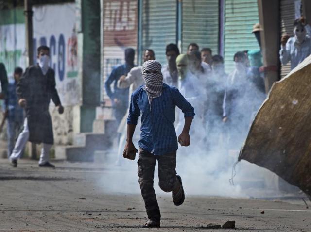 A Kashmiri youth holds bricks to throw at security personnel during a protest after Eid al-Adha prayers in Srinagar. (AP Photo) A Kashmiri youth holds bricks to throw at security personnel during a protest after Eid al-Adha prayers in Srinagar. (AP Photo)