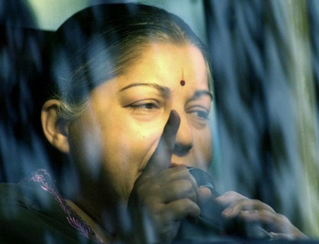 Jayalalithaa is illuminated by an in-car light as she delivers a speech from her vehicle during a election rally in Chennai, 06 May 2004. (AFP) Jayalalithaa is illuminated by an in-car light as she delivers a speech from her vehicle during a election rally in Chennai, 06 May 2004. (AFP)