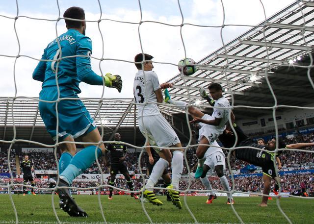 Chelsea's Diego Costa (R) scores against Swansea with a scissor kick. (AFP) Chelsea's Diego Costa (R) scores against Swansea with a scissor kick. (AFP)
