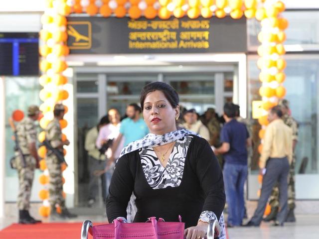 A woman who arrived in a flight from Sharjah at the Chandigarh international airport on Thursday evening, establishing regular international connectivity of the airport. (Keshav Singh/HT Photo) A woman who arrived in a flight from Sharjah at the Chandigarh international airport on Thursday evening, establishing regular international connectivity of the airport. (Keshav Singh/HT Photo)