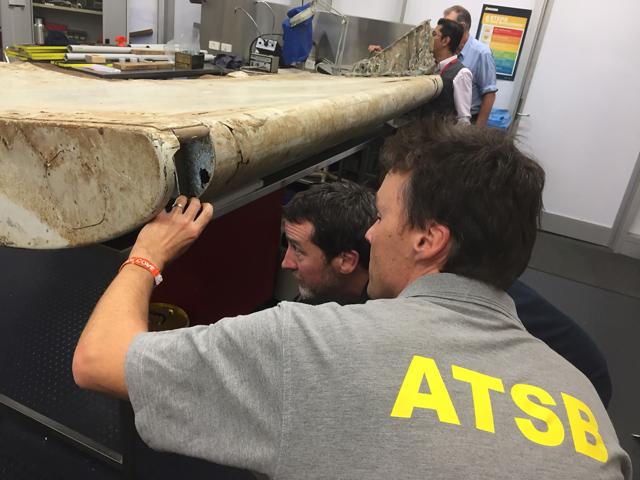 An undated handout photo released by the Australian Transport Safety Board (ATSB) and received on September 15, 2016, shows officials inspecting a large piece of debris found in Tanzania. (AFP) An undated handout photo released by the Australian Transport Safety Board (ATSB) and received on September 15, 2016, shows officials inspecting a large piece of debris found in Tanzania. (AFP)