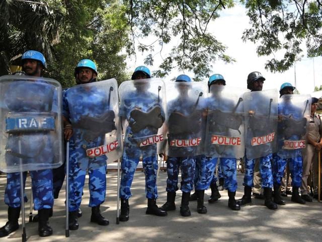 Riot police stand guard to prevent pro-Karnataka activists from entering a train station to stop trains in a protest against the SC ruling on Cauvery river dispute, in Bengaluru. (AP Photo) Riot police stand guard to prevent pro-Karnataka activists from entering a train station to stop trains in a protest against the SC ruling on Cauvery river dispute, in Bengaluru. (AP Photo)