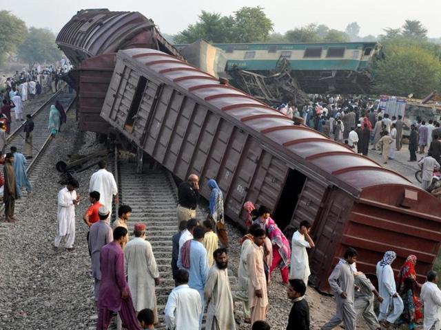 Locals mill around the scene where two trains collided near Multan in Pakistan on Thursday. (Reuters) Locals mill around the scene where two trains collided near Multan in Pakistan on Thursday. (Reuters)