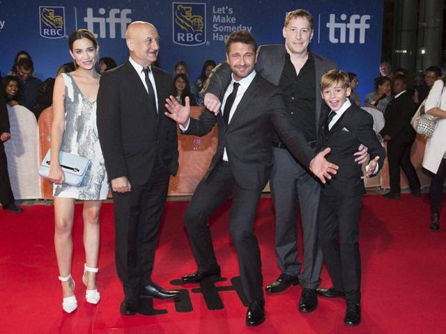 Actors Kathleen Munroe, from left, Anupam Kher, Gerard Butler, director Mark Williams and Maxwell Jenkins arrive on the red carpet for the premiere of The Headhunter's Calling during the 2016 Toronto International Film Festival. (AP) Actors Kathleen Munroe, from left, Anupam Kher, Gerard Butler, director Mark Williams and Maxwell Jenkins arrive on the red carpet for the premiere of The Headhunter's Calling during the 2016 Toronto International Film Festival. (AP)