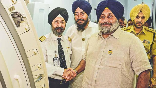 Punjab deputy CM Sukhbir Singh Badal greets a pilot of the Chandigarh-Sharjah flight on Thursday. (Photo: Facebook)