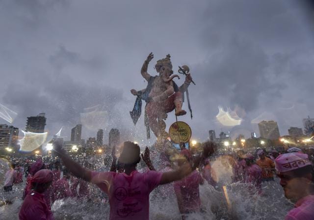 Mirror view: Devotees brave showers during an immersion procession at Girgaum Chowpatty on Thursday. (Kunal Patil / HT Photo) Mirror view: Devotees brave showers during an immersion procession at Girgaum Chowpatty on Thursday. (Kunal Patil / HT Photo)