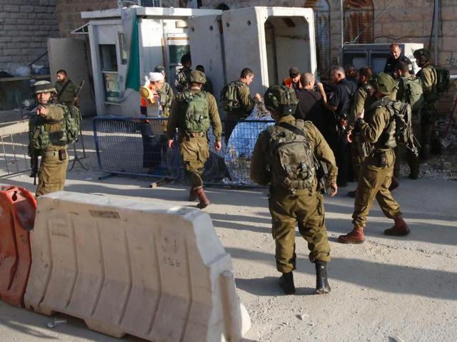 Israeli security forces gather at the scene of a reported Palestinian stabbing attack on an Israeli soldier near a Jewish settler enclave in the West Bank town of Hebron on Friday. Three alleged assailants were killed while carrying out attacks on Israelis, security forces said, shattering weeks of relative calm. (AFP) Israeli security forces gather at the scene of a reported Palestinian stabbing attack on an Israeli soldier near a Jewish settler enclave in the West Bank town of Hebron on Friday. Three alleged assailants were killed while carrying out attacks on Israelis, security forces said, shattering weeks of relative calm. (AFP)