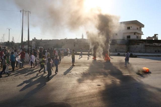 People gather near burning tyres during a demonstration against forces loyal to Syria's President Bashar al-Assad and calling for aid to reach Aleppo near Castello road in Aleppo on Wednesday. People gather near burning tyres during a demonstration against forces loyal to Syria's President Bashar al-Assad and calling for aid to reach Aleppo near Castello road in Aleppo on Wednesday.
