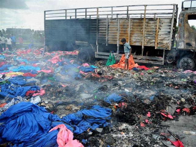 A Tamil Nadu truck set afire during protests over the Cauvery issue, in Bengaluru on Tuesday. (PTI) A Tamil Nadu truck set afire during protests over the Cauvery issue, in Bengaluru on Tuesday. (PTI)