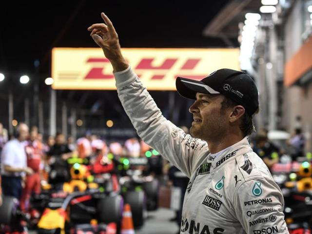 Nico Rosberg (C) waves as he celebrates his pole position while flanked between Daniel Ricciardo (L) and Lewis Hamilton (R) after the qualifying session for the Formula One Singapore Grand Prix in Singapore on September 17, 2016. (AFP) Nico Rosberg (C) waves as he celebrates his pole position while flanked between Daniel Ricciardo (L) and Lewis Hamilton (R) after the qualifying session for the Formula One Singapore Grand Prix in Singapore on September 17, 2016. (AFP)