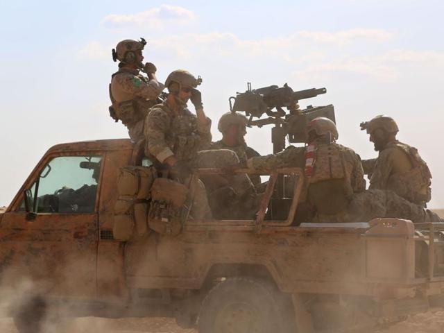 This file photo shows armed men in uniform identified by Syrian Democratic forces as US special operations forces riding in the back of a pickup truck in the village of Fatisah in the northern Syrian province of Raqqa. (AFP file photo) This file photo shows armed men in uniform identified by Syrian Democratic forces as US special operations forces riding in the back of a pickup truck in the village of Fatisah in the northern Syrian province of Raqqa. (AFP file photo)