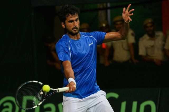 India's Saketh Myneni returns the ball to Spain's David Ferrer during their Davis Cup match. (AFP Photo) India's Saketh Myneni returns the ball to Spain's David Ferrer during their Davis Cup match. (AFP Photo)