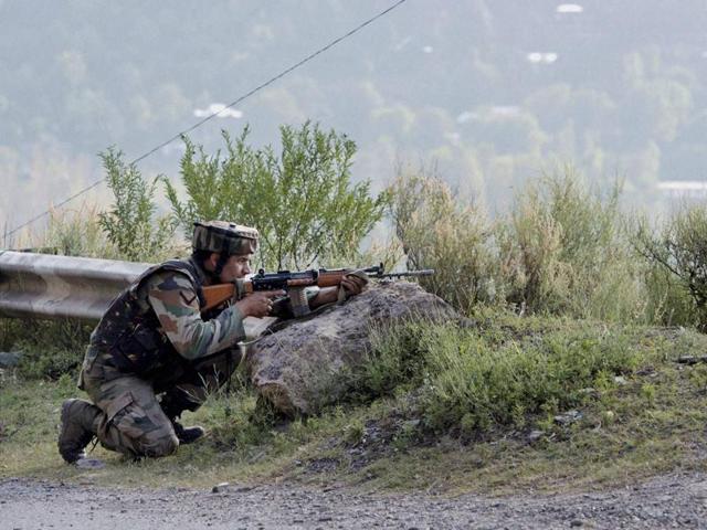 A soldier takes position near Army Brigade camp during a terror attack in Uri on Sunday.(PTI Photo)