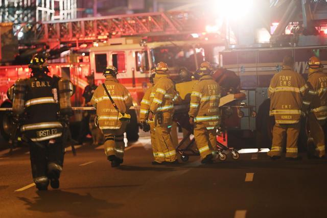 Firefighters and emergency workers gather at the scene of an explosion in Manhattan, New York City. (AFP)