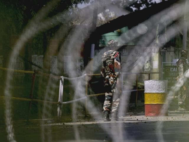 Soldiers guard the army base which was attacked by suspected rebels in the town of Uri, Jammu and Kashmir.(AP Photo)