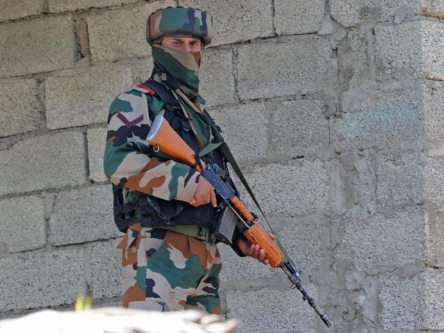 A soldier takes up a position near the site of a gunbattle in Uri on Sunday.(AFP Photo)