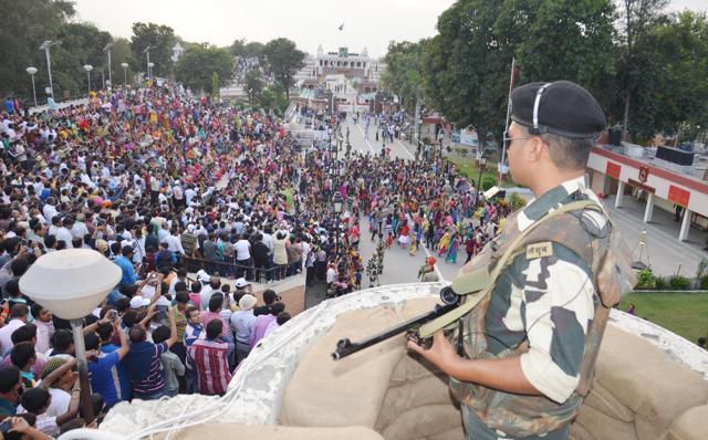 A BSF jawan stands guard during the retreat ceremony at Attari border in Amritsar on Tuesday. (HT Photo)