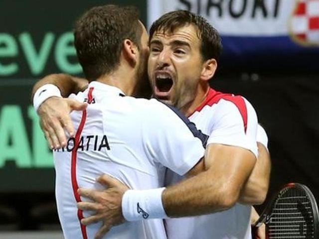 Croatia's Marin Cilic and Ivan Dodig react after winning their men's doubles match against France. (REUTERS) Croatia's Marin Cilic and Ivan Dodig react after winning their men's doubles match against France. (REUTERS)