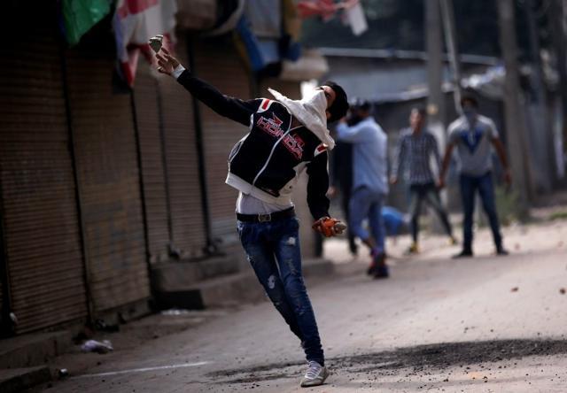 A protester throws a stone during a protest in Kashmir, Srinagar. (Reuters File Photo) A protester throws a stone during a protest in Kashmir, Srinagar. (Reuters File Photo)