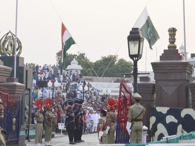 Jawans onm both the sides taking off the flags during retreat ceremony at Attari-Wagah border in Amritsar on Monday. (Sameer Sehgal/HT Photo)