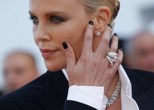 Charlize Theron poses on red carpet as she arrives for the screening of the film The last Face in competition at the 69th Cannes Film Festival in Cannes, France, May 20. (REUTERS)