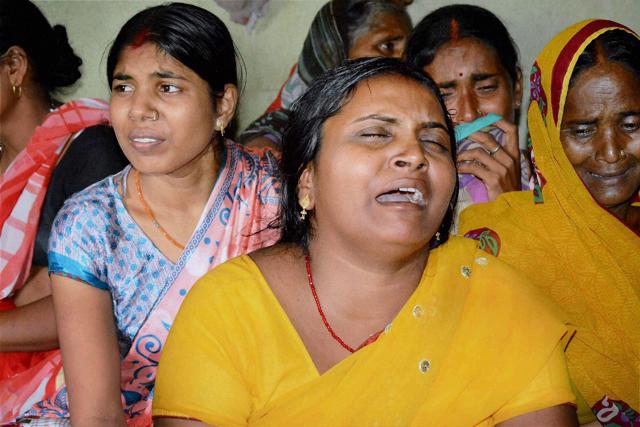 Wife of slain soldier Sunil Kumar Vidarthi mourns in Gaya on Monday. (PTI)