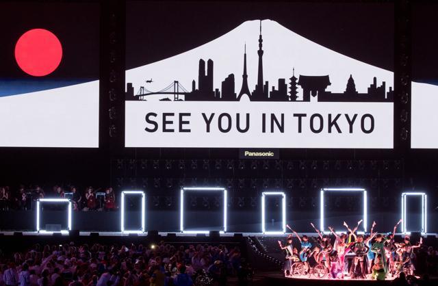 In this photo released by the IOC, Koichi Omae and four female dancers are joined on stage by GIMICO, Aya Sato, Bambi and Akira Hiyama as a sign saying "see you in Tokyo" appears. (AP Photo) In this photo released by the IOC, Koichi Omae and four female dancers are joined on stage by GIMICO, Aya Sato, Bambi and Akira Hiyama as a sign saying "see you in Tokyo" appears. (AP Photo)
