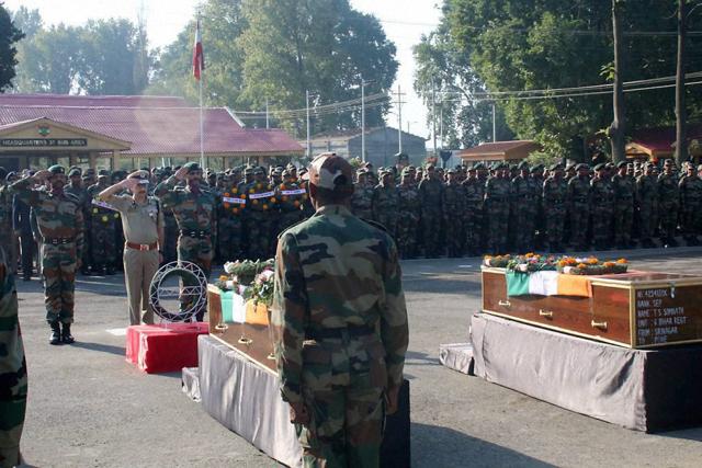 A senior Police officer paying tribute to the soldiers killed in Uri attack in Srinagar on Monday. (PTI)