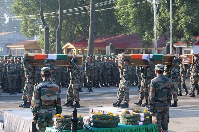Army jawans carrying the coffins of their colleagues killed in Uri attack in Srinagar on Monday. (PTI)