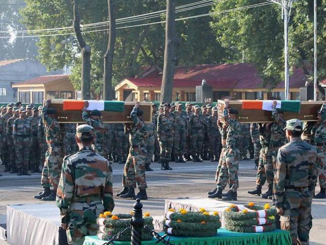 Indian army soldiers pay last respects to soldiers who died in the attack in Uri, at a ceremony in Srinagar.(Indian Army Handout)