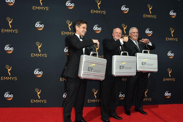 Ernst & Young representatives arrive for the 68th Emmy Awards on September 18, 2016 at the Microsoft Theatre in Los Angeles. / AFP PHOTO / Robyn Beck (AFP)