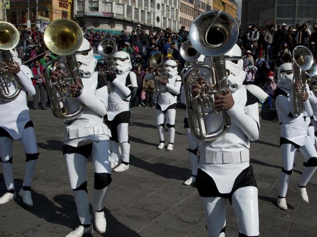 A student band dressed as storm troopers play the Star Wars song Imperial March through downtown La Paz, Bolivia. The band was led by their band director who was dressed as Darth Vader. The band, from the indigenous Aymara town of Caracollo, Oruro, was noticed at a local school band competition in Cochabamba and invited by television stations in the capital. (AP)