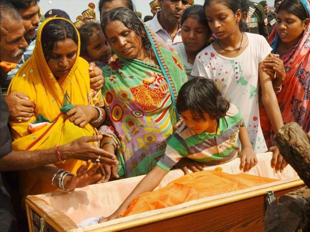 Wife of Naik Sunil Kumar Vidyarthi (Left) and children pay tributes during his funeral in Gaya on Tuesday (PTI) Wife of Naik Sunil Kumar Vidyarthi (Left) and children pay tributes during his funeral in Gaya on Tuesday (PTI)