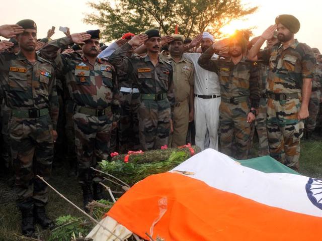 Soldiers during the last rite of Ravi Paul with full military honours at his village - Sarwah in Samba district on Monday. (Nitin Kanotra/HT Photo) Soldiers during the last rite of Ravi Paul with full military honours at his village - Sarwah in Samba district on Monday. (Nitin Kanotra/HT Photo)