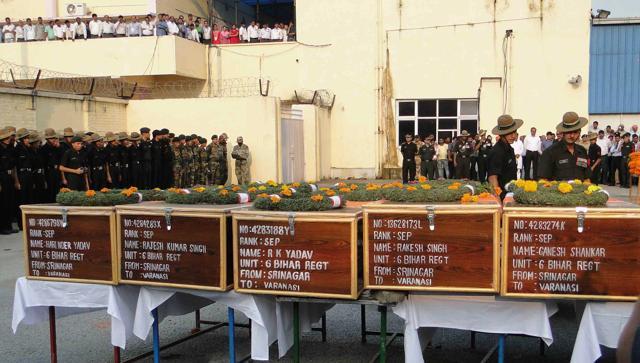 Indian army officers pay tribute next to coffins carrying the bodies of soldiers killed in Uri terror attack. (AFP Photo)