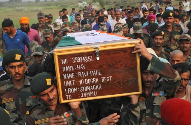 Relatives and villagers watch the funeral of Indian army soldier Gangadhar Dalai, who was killed in a militant attack in Uri, Kashmir, in Jamuna Balia village, west of Kolkata.(AP)