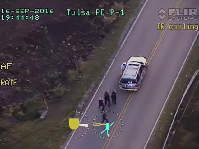 Terence Crutcher, top, is pursued by police officers as he walks to an SUV in Tulsa, Okla. (Tulsa Police Department via AP) Terence Crutcher, top, is pursued by police officers as he walks to an SUV in Tulsa, Okla. (Tulsa Police Department via AP)