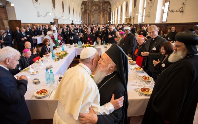 Pope Francis (L) hugs Ecumenical Patriarch Bartholomew I (R) during the inter-religious meeting "Prayer for Peace" in Assisi, Italy, on Tuesday. (Reuters)