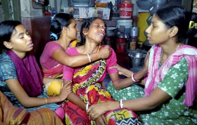 Neighbours console mother of Sepoy Gangadhar Dolui, who was killed in militant attack in Uri, in Howrah. (PTI Photo)