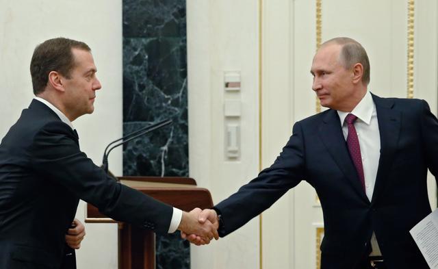 Russian President Vladimir Putin, right, shakes hands with Prime Minister Dmitry Medvedev prior to the cabinet meeting in Moscow's Kremlin on Monday. (AP) Russian President Vladimir Putin, right, shakes hands with Prime Minister Dmitry Medvedev prior to the cabinet meeting in Moscow's Kremlin on Monday. (AP)
