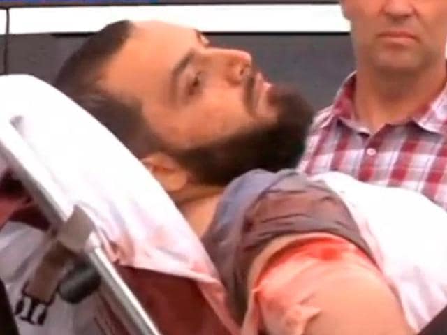 A still image captured from a video from WABC television shows a conscious man believed to be New York bombing suspect Ahmad Khan Rahami being loaded into an ambulance after a shoot-out with police in Linden, New Jersey. (REUTERS) A still image captured from a video from WABC television shows a conscious man believed to be New York bombing suspect Ahmad Khan Rahami being loaded into an ambulance after a shoot-out with police in Linden, New Jersey. (REUTERS)