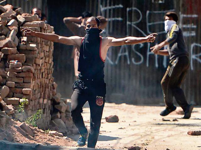 A Kashmiri holds bricks to throw at security personnel , September 13(AP)