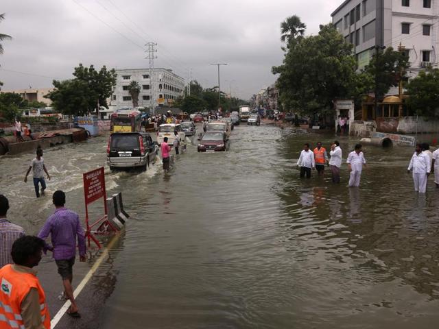 Bystanders watch rain water flood a street following heavy rain in Nijampet, a low lying area on the outskirts of Hyderabad on September 21, 2016. (AFP Photo) Bystanders watch rain water flood a street following heavy rain in Nijampet, a low lying area on the outskirts of Hyderabad on September 21, 2016. (AFP Photo)