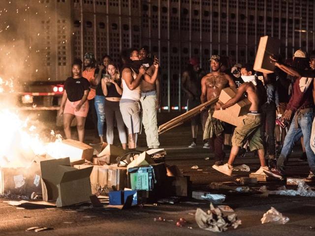 Protestors put cargo from tractor trailers onto a fire on I-85 (Interstate 85) during protests following the death of a man shot by a police officer September 21, 2016 in Charlotte, North Carolina.(AFP)