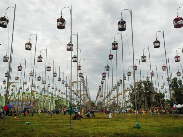 When they’re ready to sing, the cages are lifted onto hooks and raised high into the air. Birds sit in their cages, hoisted on poles during a bird-singing contest. (AFP)