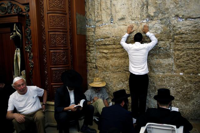 Ultra-Orthodox Jewish worshippers pray at the Western Wall in Jerusalem's Old City on Tisha B'Av, a day of fasting and lament. (Reuters)