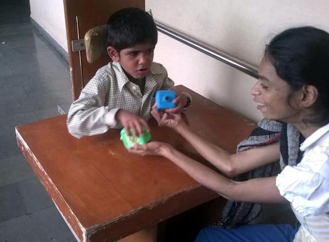 Ankita Saxena with a child at Navjeevan Vidhyalaya in Shujalpur town of Shajapur district.(HT Photo)